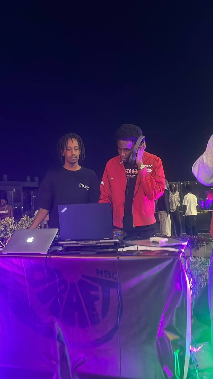 Kibiru Raymond behind the decks at an outdoor event